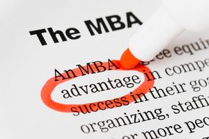 A close-up image of a printed document with the heading ‘The MBA’ in bold black text at the top. Below the heading, the phrase ‘An MBA advantage’ is visible, with the word ‘advantage’ circled in bright red ink. A red marker is positioned near the circled word, suggesting that it was just used to highlight the term. The surrounding text is slightly blurred, keeping the focus on the circled word and the marker. The composition conveys emphasis on the benefits or value of an MBA program.